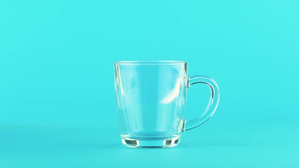 Fruit Orange Multifruit Juice Cold Beverage Drink Pooring Into Glass Mug with Rounded Handle alt