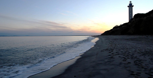 Sunset On Rocky Beach And Lighthouse