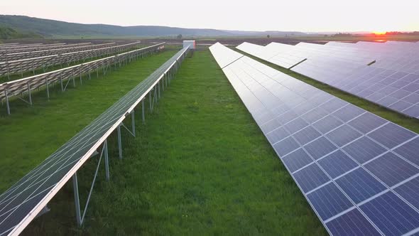 Green field with solar energy panels for renewable electricity production. alt