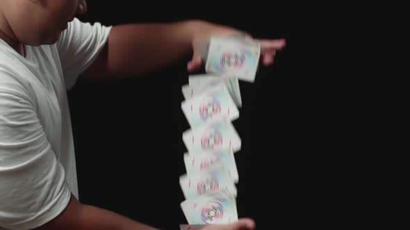 Magician Starts Showing His Trick With Cards, Cards Cascading Down alt