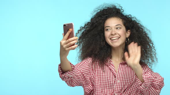 Slow Motion of Cheerful Woman Video Chat with Friend Saying Hello and Waving Hand at Smartphone