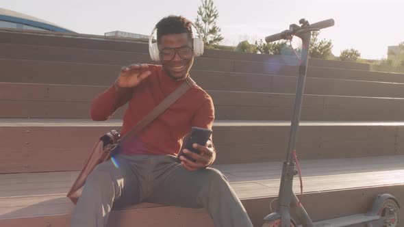Energetic Black Man Enjoying Music in Headphones Outdoors alt