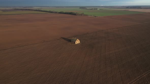 self-isolation in a lonely house in the middle of a field top view from a drone.