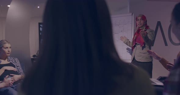 Businesswoman in Wheelchair Having Business Meeting with Team at Modern Office