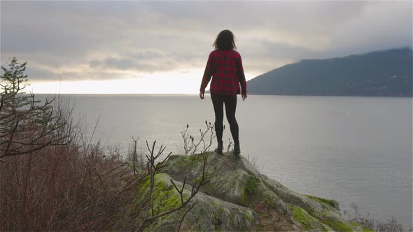 Adventurous Girl Looking at the Beautiful Scenery on the West Pacific Ocean Coast alt