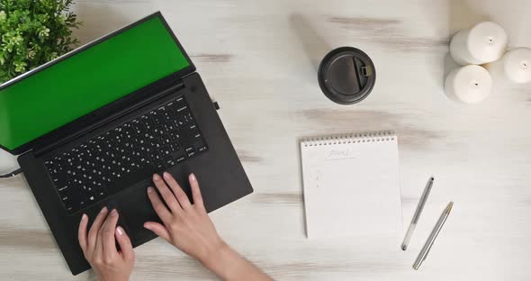 Top View Camera Slowly Moves Above Wooden Table on Which Laptop Notepad alt