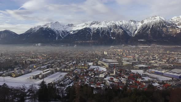 Aerial view of Innsbruck surrounded by mountains alt