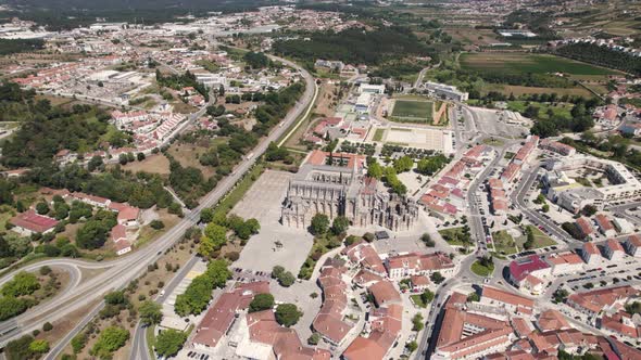Aerial panoramic view over Batalha monastery and surrounding landscape, Portugal alt
