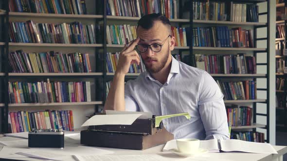 Young writer ponders a book  alt