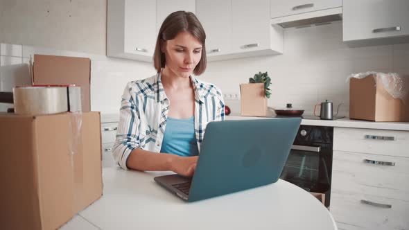 Woman Working at Home in New Flat