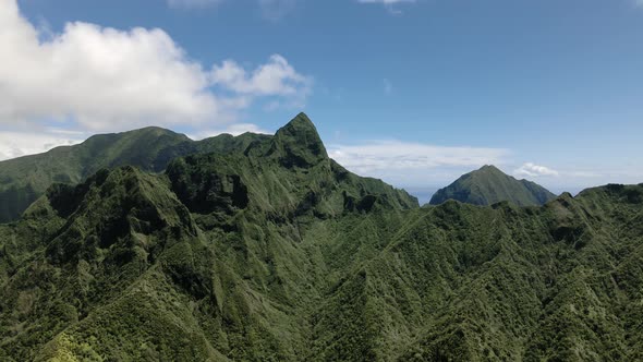Drone view of sharp green peak of Maui mountain range, Hawaiian highlands, USA alt