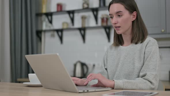 Surprised Young Woman Feeling Shocked on Laptop at Home  alt