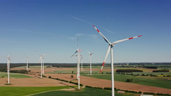 A Drone Shot of a Massive Wind Farm in Agricultural Land alt