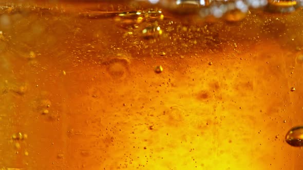 Super Slow Motion Detail Shot of Beer Bubbles in Glass at 1000Fps alt
