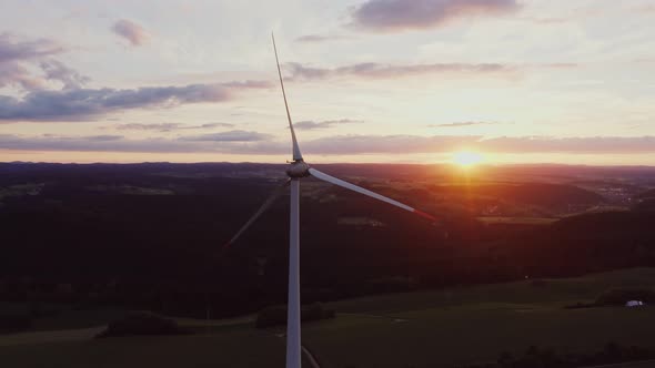 Wind Turbine in the Bright Rays of the Rising Sun Bird's Eye View