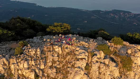 Aerial view of group practicing yoga at top of mountain, Veli Losinj, Croatia. alt