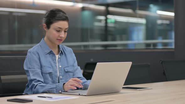 Indian Woman Working on Laptop in Office alt