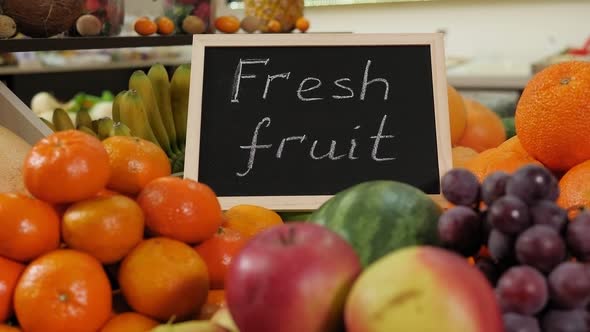 Closeup of Various Fruits in a Grocery Store with a Sign for FRESH FRUIT alt