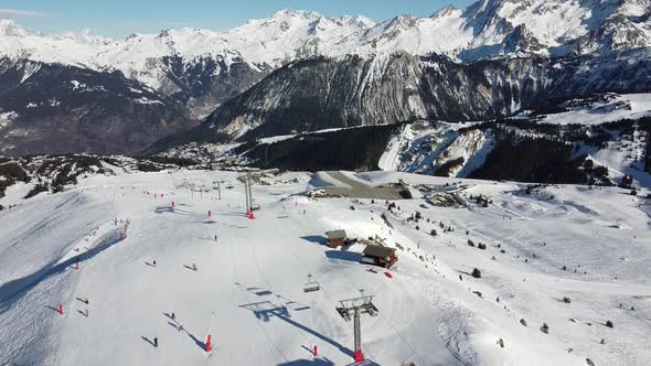 Aerial View of the Alps Mountains in France. Mountain Tops Covered in Snow. Alpine Ski Facilities