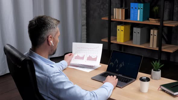 Man Trader Broker Talks to Potential Investor Uses Laptop Stock Exchange Chart alt