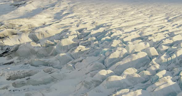 Aerial helicopter shot, push in and tilt down towards Alaskan city by the bay, drone footage alt