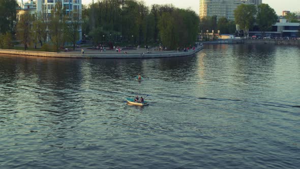 An Aerial View of a Boat That Floats Along a River in the City Centre alt