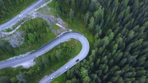 Aerial View of Winding Road in the Mountains and Green Forest alt