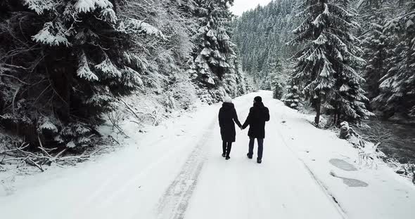 Aerial Overpass Steam Goes on the Road in the Woods During a Snowy Winter alt