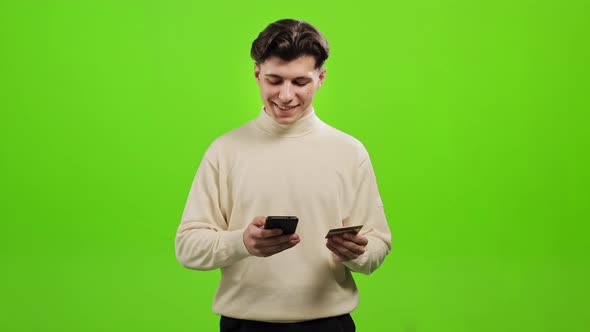 The Man is Entering His Bank Card Details Into His Smartphone alt