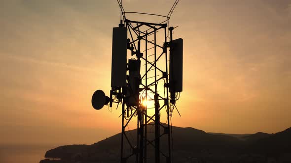 Amazing close up sunset drone view of silhouette of cell tower