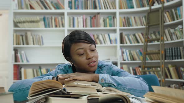 Tired African Female Student Girl Lying on the Books alt