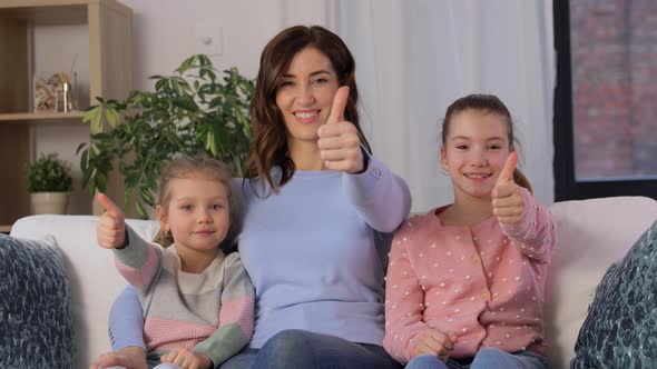 Mother and Daughters Showing Thumbs Up at Home alt