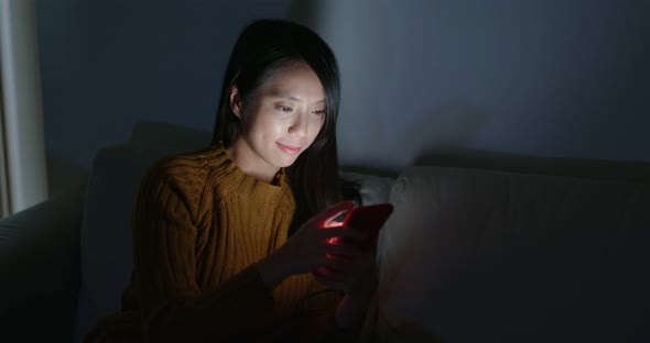 Woman use of mobile phone at night alt