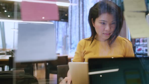 creative agency asian female casual cloth video conference online meeting working with laptop alt