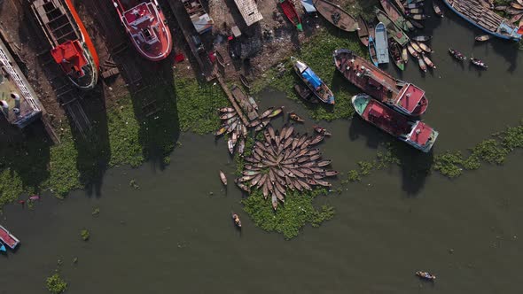 Boat wharf with shipyard at the shore of sea coast. Aerial circling shot alt