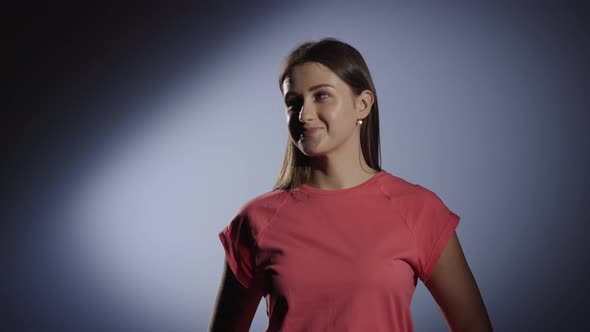 Portrait of a Cute Young Girl with Tattoos Smiling Coquettishly and Showing Thumbs Up alt