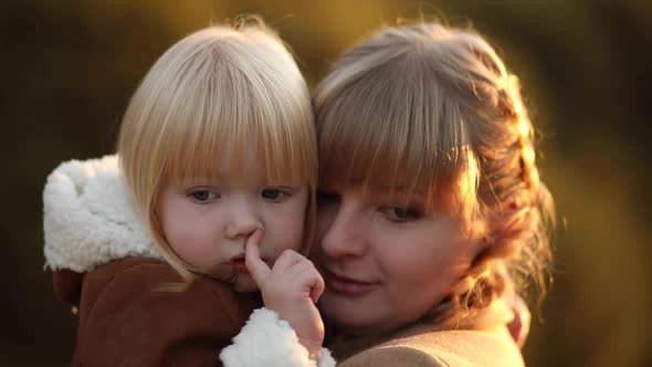 Mom Hugs Her Baby Girl Gently