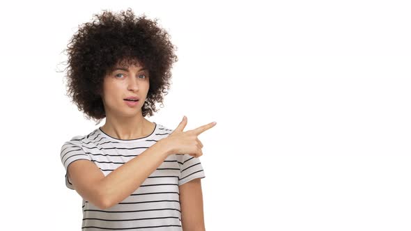 Portrait of Female Person Having Afro Hairstyle Pointing Index Finger Looking at Something with alt