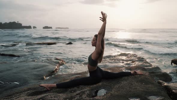 Woman Doing Stretching Exercises on Beach Ocean on Background Slow Motion alt