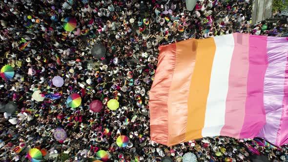 aerial drone shot of many people waving the pride flag in pride parade in mexico city alt