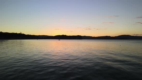Flying quickly over waves up into the mountains of New Zealand alt