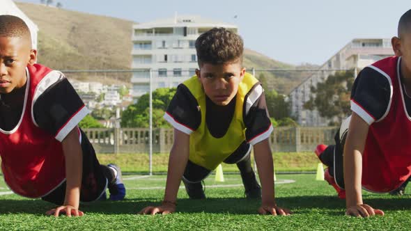 Soccer kids exercising in a sunny day alt