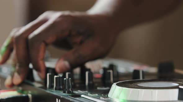 Closeup Unrecognizable DJ Man African Male Finger Using Mixer Controller Desk in Club Musical Studio alt