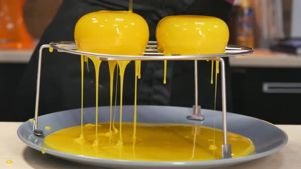 Coating Mousse Cakes with Yellow Mirror Glaze in a Pastry Shop