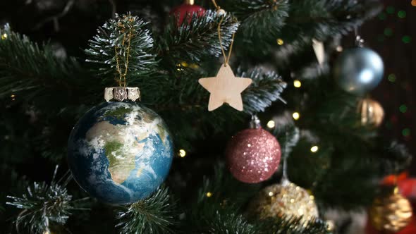 Animated Christmas Toy on a Tree in Shape of Planet, Close Up Shot