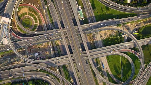 Aerial View of Highway Road Interchange with Busy Urban Traffic Speeding on Road alt