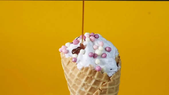 Close-up, Ice Cream in a Waffle Cone, Poured Over Topping, Dessert Decoration. Delicious Ice Cream