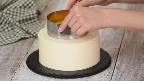 The Pastry Chef Prepares and Decorated Cake with Orange Jelly