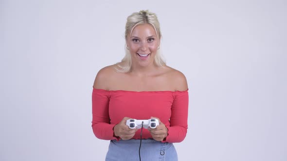 Happy Young Beautiful Blonde Woman Playing Games and Winning alt