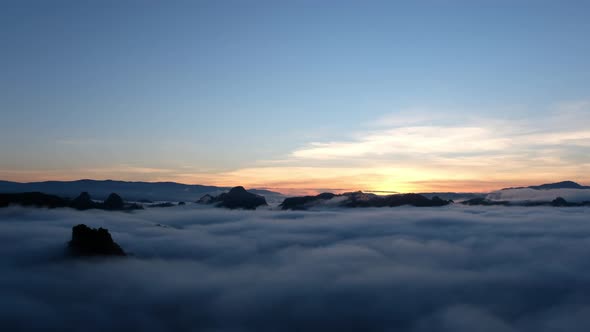 Landscape of mountains and hills with the sea of fog before sunrise